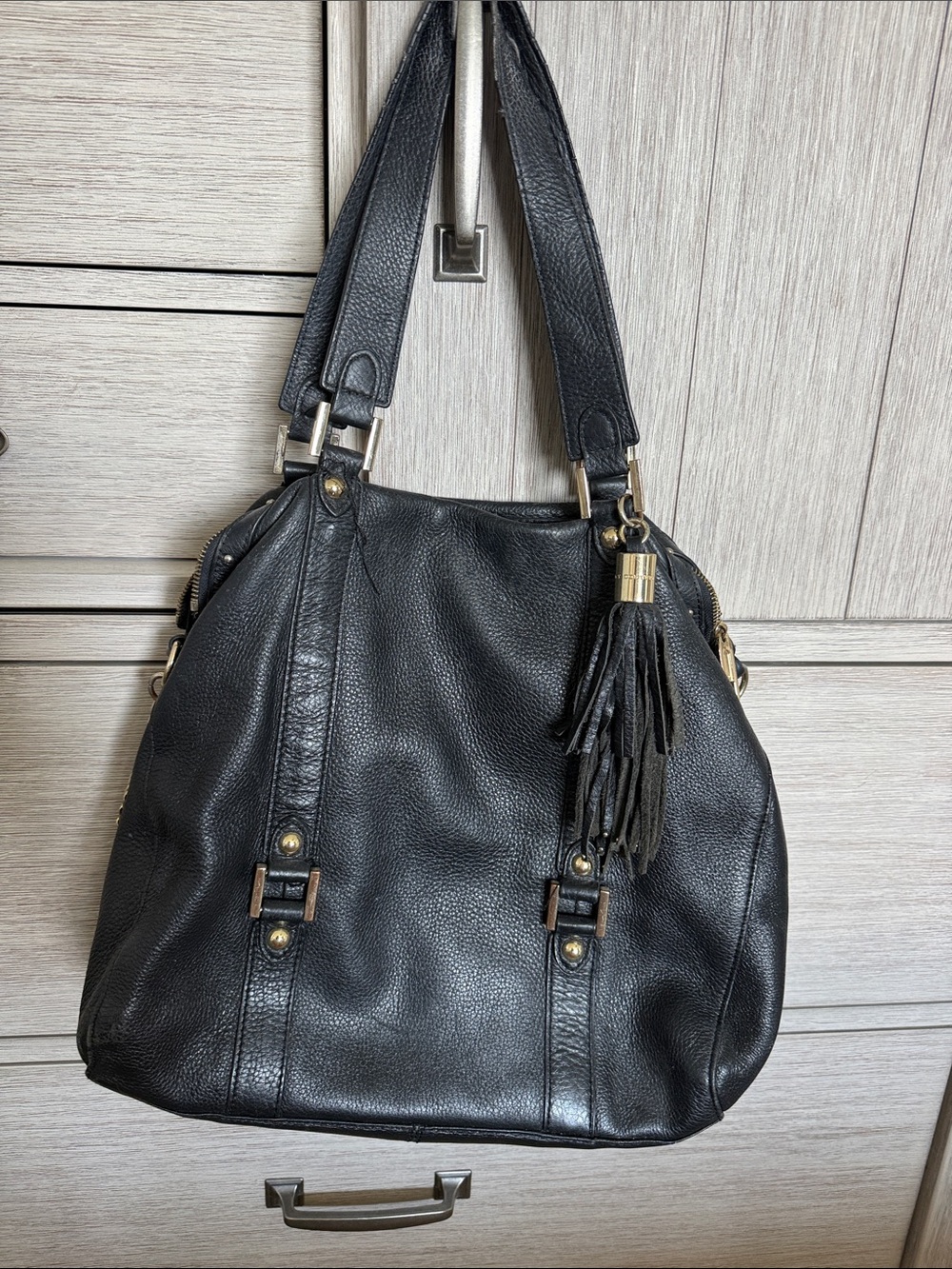 Juicy Couture Black Leather Shoulder Bag with Tassel Accent